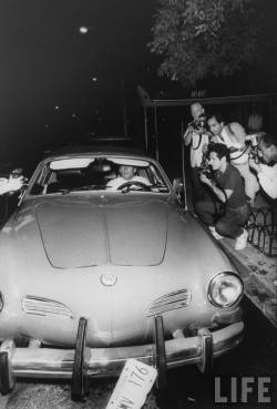 odetojohn:  John F. Kennedy, Jr., arriving for his aunt Lee Radziwill’s wedding to Herbert Ross in his Volkswagen Karman Ghia, is surrounded by photographers, 9/24/88, New York, NY. 