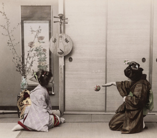 Hand-colored photo of two girls playing with &lsquo;temari&rsquo; (thread ball). Circa about