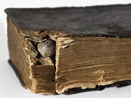 thecivilwarparlor:Musket Ball Stuck in the Pages of a Bible,  which likely saved the life of the sol