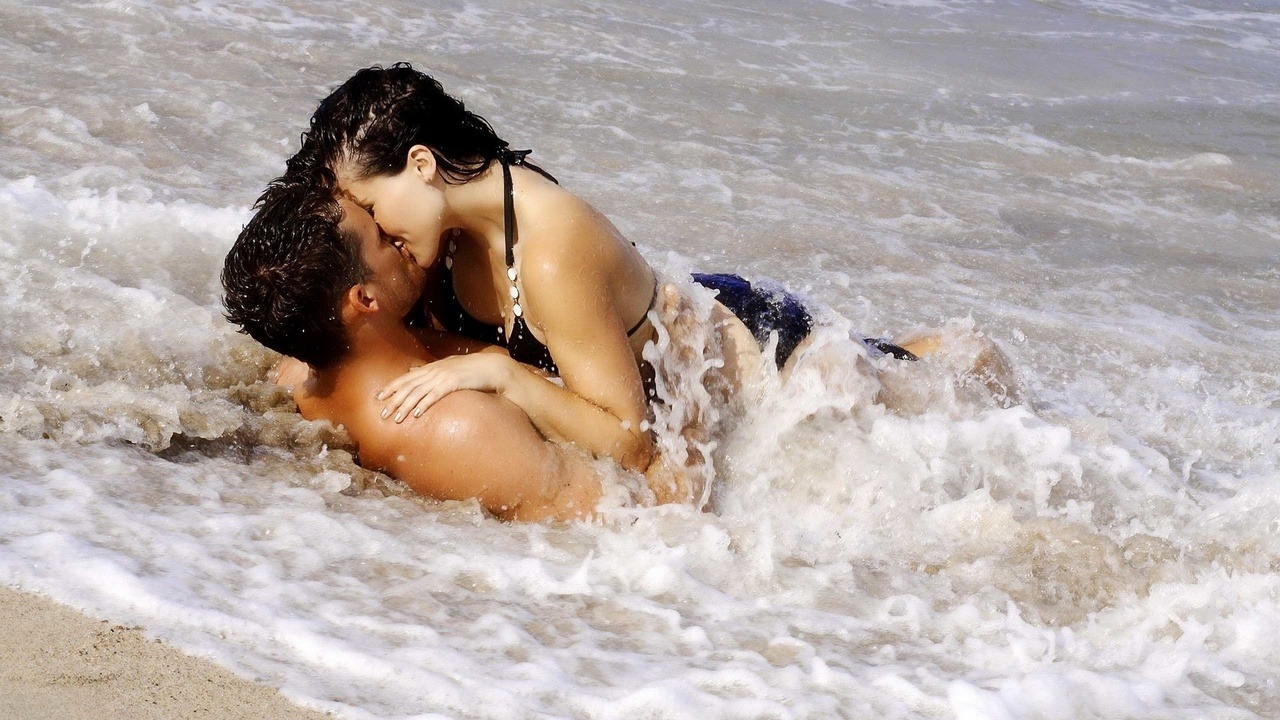 Women kissing in the rain