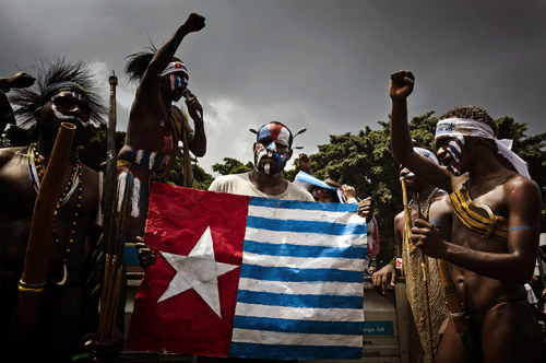 politics-war:Protesters wear traditional costumes as they display the Morning Star flag. Demonstrato