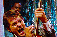 fybacktothefuture:      DETAILS: Marty McFly mimics famous rock stars during the later part of his performance at the school dance, when he starts playing heavy metal. His kicking of speakers (The Who), playing the guitar while lying down (Angus Young of 