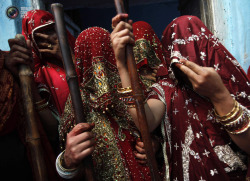 allasianflavours:  Veiled Hindu women hold bamboo sticks as they celebrate Lathmar Holi at Barsana in the northern Indian state of Uttar Pradesh. ADNAN ABIDI/REUTERS 