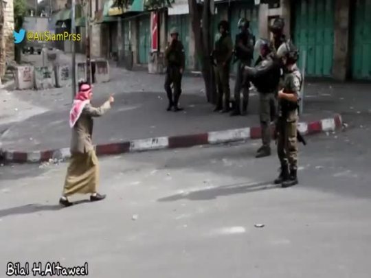 from-palestine:    An elder Palestinian man trying to stop Israeli Occupation Forces from shooting young kids in Hebron - Palestine.