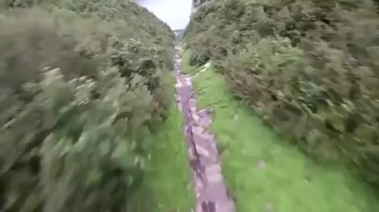 Wingsuit flying through a canyon.