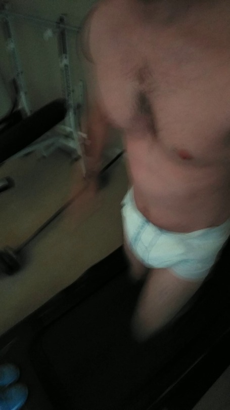 loveablediaperboy:I’ve seen tons of people changing into diapers in gyms but I’m not really into going out in public diapered.  So I decided to workout in just a diaper at home today because… why not 