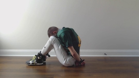 dudeboundjake:Hot video of Jock21 of Tumblr wearing my football jersey and cleats, while hogtied and tape gagged. WOOF!  Not sure why he’s putting in all that effort to get out. Doesn’t seem like anything is happening to him. Just relax &